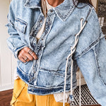 Light wash denim jacket with rope and grommet detail on the front.