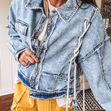 Light wash denim jacket with rope and grommet detail on the front.