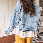 Light wash denim jacket with rope and grommet detail on the front.