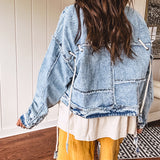 Light wash denim jacket with rope and grommet detail on the front.