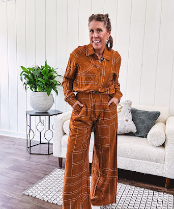 Lightweight rust button front long sleeved shirt with collar and white geometric stitching print throughout.