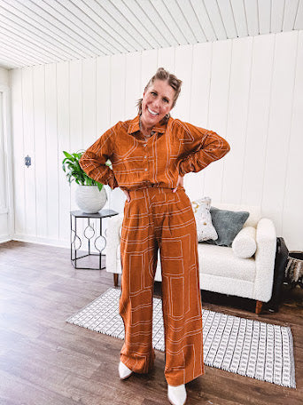 Lightweight rust button front long sleeved shirt with collar and white geometric stitching print throughout.