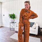Lightweight rust button front long sleeved shirt with collar and white geometric stitching print throughout.
