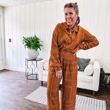 Lightweight rust button front long sleeved shirt with collar and white geometric stitching print throughout.