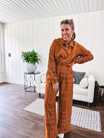 Lightweight rust button front long sleeved shirt with collar and white geometric stitching print throughout.