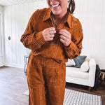 Lightweight rust button front long sleeved shirt with collar and white geometric stitching print throughout.