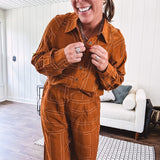 Lightweight rust button front long sleeved shirt with collar and white geometric stitching print throughout.