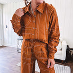 Lightweight rust button front long sleeved shirt with collar and white geometric stitching print throughout.