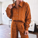 Lightweight rust button front long sleeved shirt with collar and white geometric stitching print throughout.