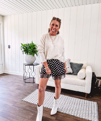 Black satin shorts with white polka dots, elastic waist and lace trim at the hems.