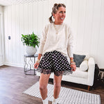 Black satin shorts with white polka dots, elastic waist and lace trim at the hems.