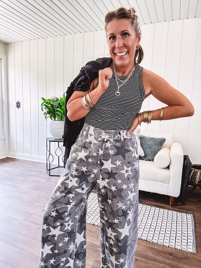 Lightweight grey, cream and black washed star graphic wide leg pants with waffle texture insert on the sides of the legs.