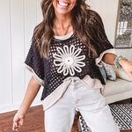 Open weave crochet sweater with 3/4 sleeves and large contrasting crochet flower on the front and contrasting trim. Oversized. Available in multiple colors.
