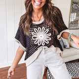 Open weave crochet sweater with 3/4 sleeves and large contrasting crochet flower on the front and contrasting trim. Oversized. Available in multiple colors.