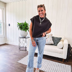 Chic black mock neck zip up back cap sleeve blouse with elastic, balloon waist.