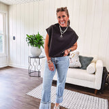 Chic black mock neck zip up back cap sleeve blouse with elastic, balloon waist.