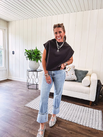 Chic black mock neck zip up back cap sleeve blouse with elastic, balloon waist.