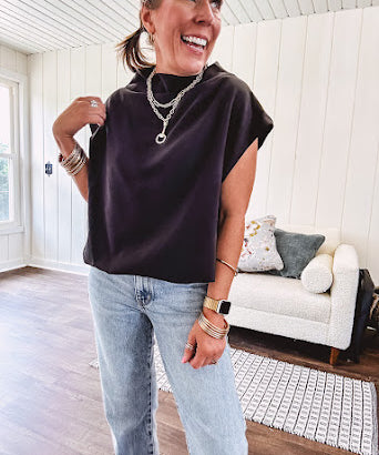 Chic black mock neck zip up back cap sleeve blouse with elastic, balloon waist.