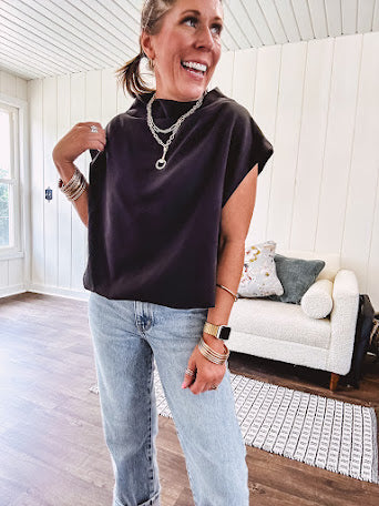 Chic black mock neck zip up back cap sleeve blouse with elastic, balloon waist.