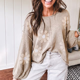 Soft, lightweight, nearly sheer knit pullover  with long sleeves, exposed seams at the shoulders and down the center with large daisy florals throughout. Available in multiple colors.