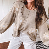 Soft, lightweight, nearly sheer knit pullover  with long sleeves, exposed seams at the shoulders and down the center with large daisy florals throughout. Available in multiple colors.