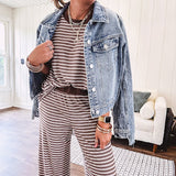 Medium wash non-stretch denim jacket with classic trim, raw, uneven hem and cuffs with silver hardware and cropped length.