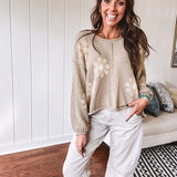 Soft, lightweight, nearly sheer knit pullover  with long sleeves, exposed seams at the shoulders and down the center with large daisy florals throughout. Available in multiple colors.