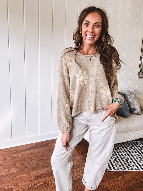 Soft, lightweight, nearly sheer knit pullover  with long sleeves, exposed seams at the shoulders and down the center with large daisy florals throughout. Available in multiple colors.