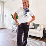 Buttery soft black lounge pants with white striping down the sides and elastic waist with pleated front.