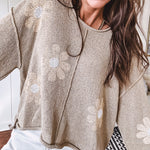 Soft, lightweight, nearly sheer knit pullover  with long sleeves, exposed seams at the shoulders and down the center with large daisy florals throughout. Available in multiple colors.