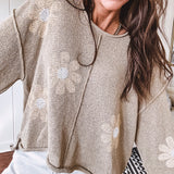 Soft, lightweight, nearly sheer knit pullover  with long sleeves, exposed seams at the shoulders and down the center with large daisy florals throughout. Available in multiple colors.