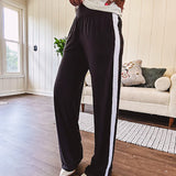 Buttery soft black lounge pants with white striping down the sides and elastic waist with pleated front.