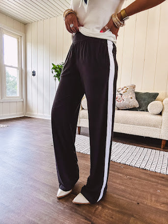 Buttery soft black lounge pants with white striping down the sides and elastic waist with pleated front.
