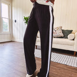 Buttery soft black lounge pants with white striping down the sides and elastic waist with pleated front.