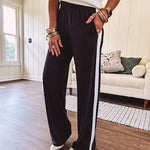 Buttery soft black lounge pants with white striping down the sides and elastic waist with pleated front.