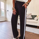 Buttery soft black lounge pants with white striping down the sides and elastic waist with pleated front.