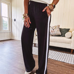 Buttery soft black lounge pants with white striping down the sides and elastic waist with pleated front.