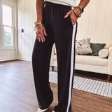 Buttery soft black lounge pants with white striping down the sides and elastic waist with pleated front.