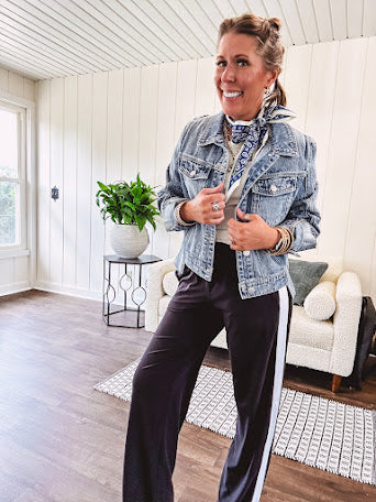 Buttery soft black lounge pants with white striping down the sides and elastic waist with pleated front.