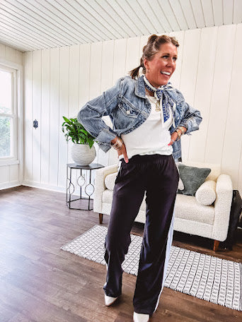 Buttery soft black lounge pants with white striping down the sides and elastic waist with pleated front.
