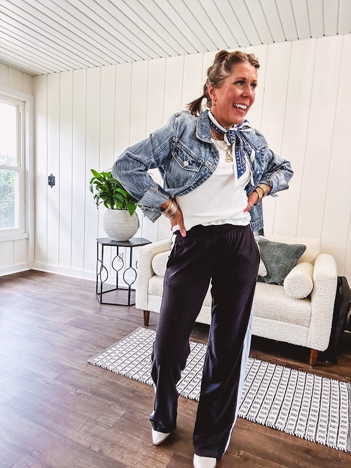 Buttery soft black lounge pants with white striping down the sides and elastic waist with pleated front.