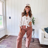 Light copper denim barrel style jeans with ankle length and twisted seam detail on the sides.
