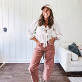 Light copper denim barrel style jeans with ankle length and twisted seam detail on the sides.