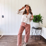 Light copper denim barrel style jeans with ankle length and twisted seam detail on the sides.