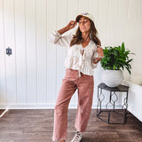 Light copper denim barrel style jeans with ankle length and twisted seam detail on the sides.