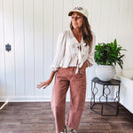 Light copper denim barrel style jeans with ankle length and twisted seam detail on the sides.