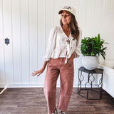 Light copper denim barrel style jeans with ankle length and twisted seam detail on the sides.