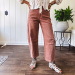 Light copper denim barrel style jeans with ankle length and twisted seam detail on the sides.
