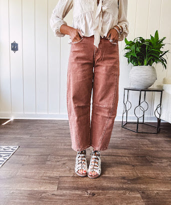 Light copper denim barrel style jeans with ankle length and twisted seam detail on the sides.