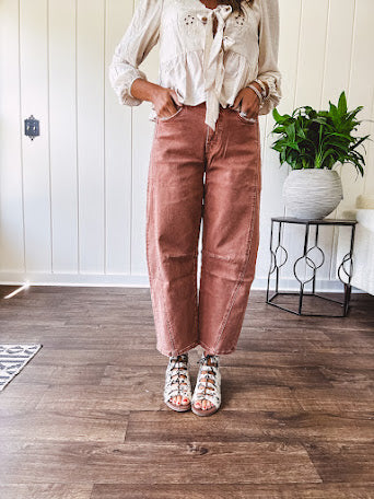 Light copper denim barrel style jeans with ankle length and twisted seam detail on the sides.